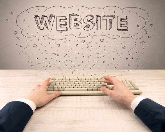 Website migration on HubSpot CMS - hands on a keyboard writing Website