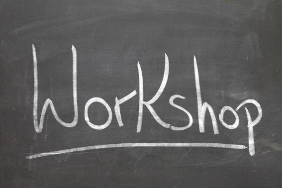 Workshop word in white chalk handwriting on the blackboard